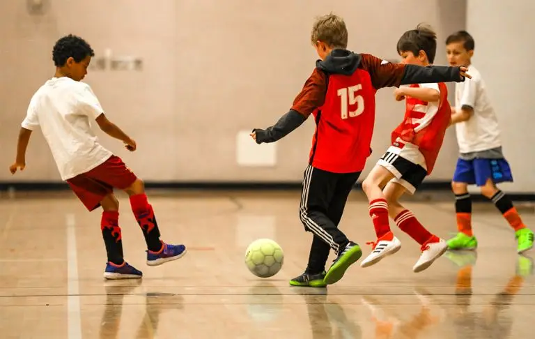 Kids playing indoor soccer.