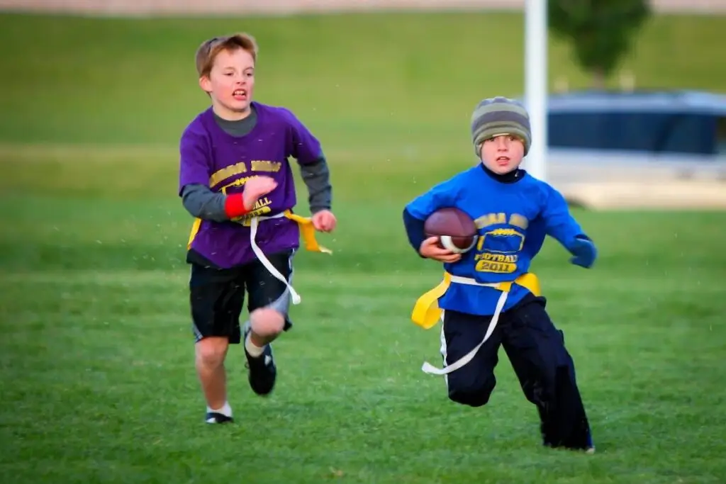 Two kids playing flag football