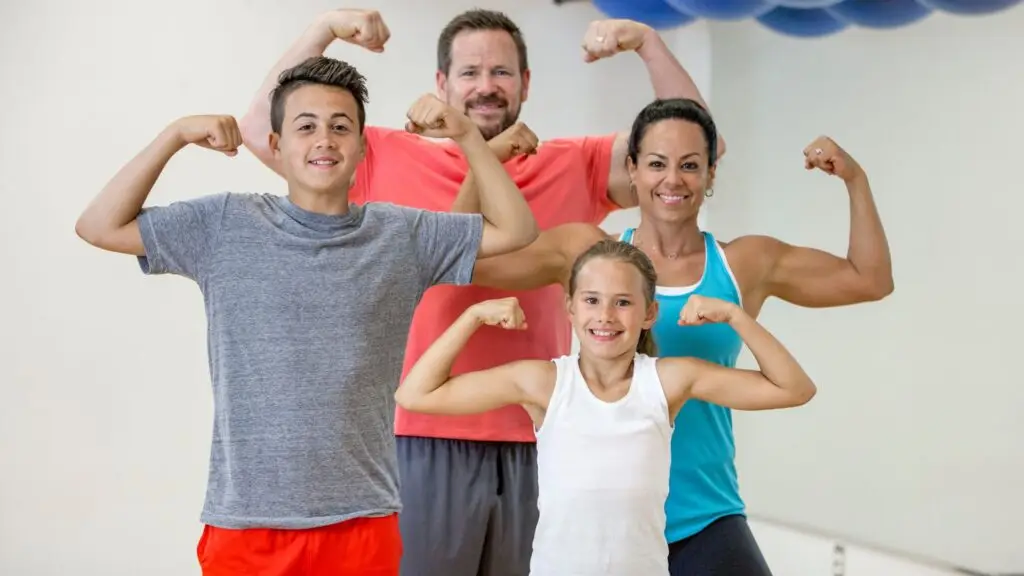 A family posing with their muscles flexed.