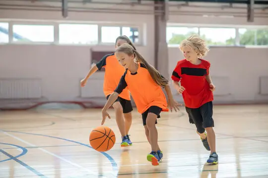 A picture of kids playing basketball