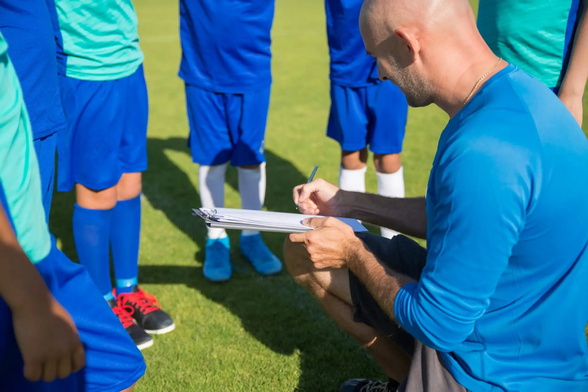 A coach talking to his team of soccer players.