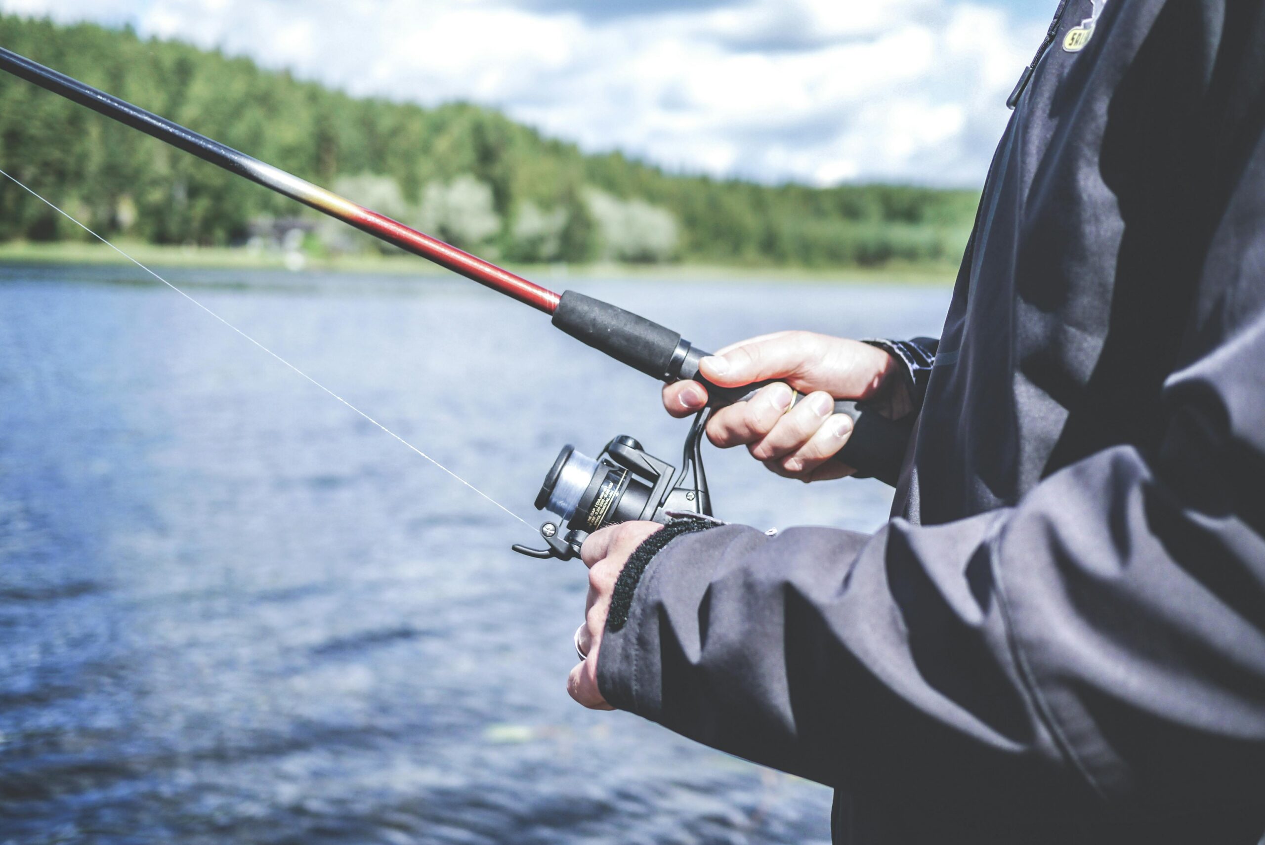 A picture of a man holding a fishing rod after casting